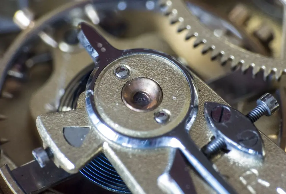 Close-up macro of metallic gears showing wheel teeth and pinions