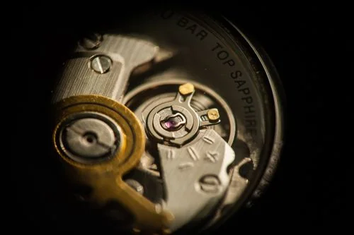 Macro shot of polished mechanical watch gears and synthetic ruby bearings